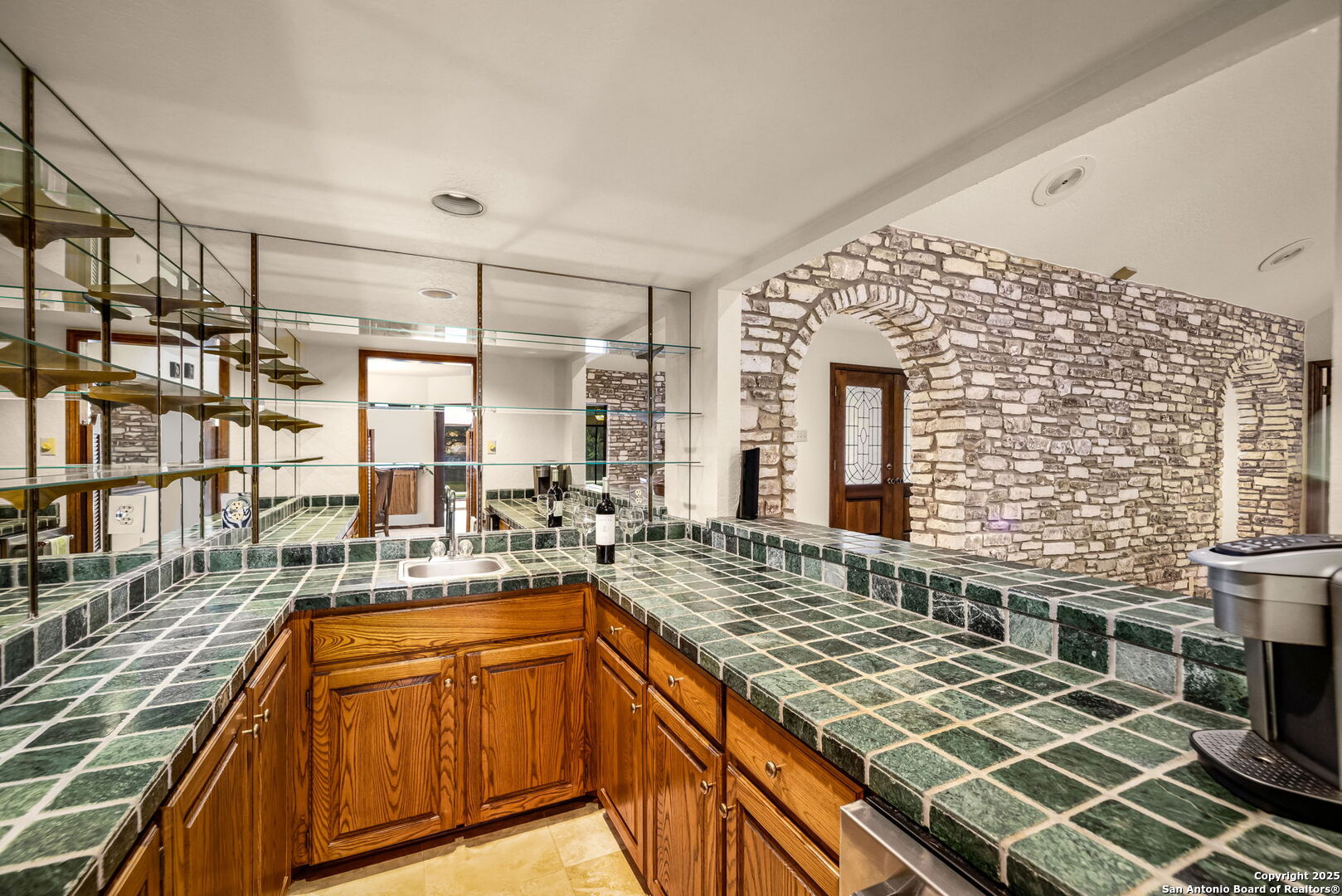 9606 Meadow Rue Garden Ridge, TX 78266 - Photo 22 of 60 a large kitchen with kitchen island granite countertop a sink and cabinets