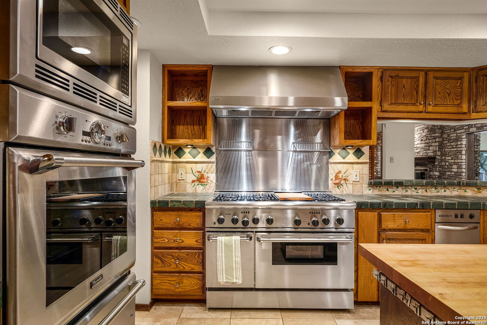 9606 Meadow Rue Garden Ridge, TX 78266 - Photo 25 of 60 a stove top oven sitting inside of a kitchen