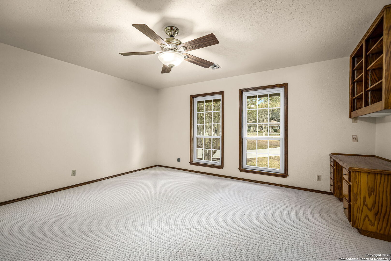 9606 Meadow Rue Garden Ridge, TX 78266 - Photo 35 of 60 an empty room with windows and fan
