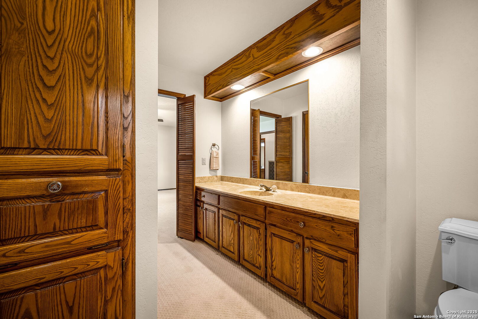 9606 Meadow Rue Garden Ridge, TX 78266 - Photo 37 of 60 a spacious bathroom with a granite countertop sink a toilet and a shower