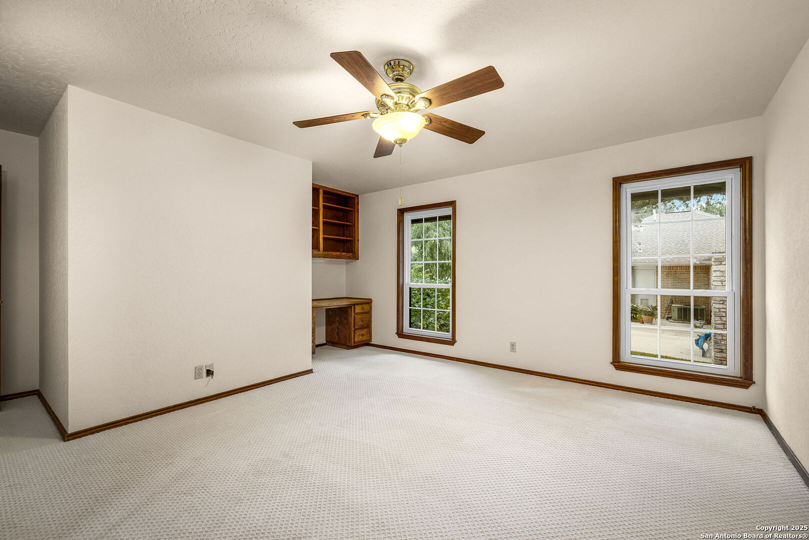 9606 Meadow Rue Garden Ridge, TX 78266 - Photo 40 of 60 an empty room with ceiling fan and windows