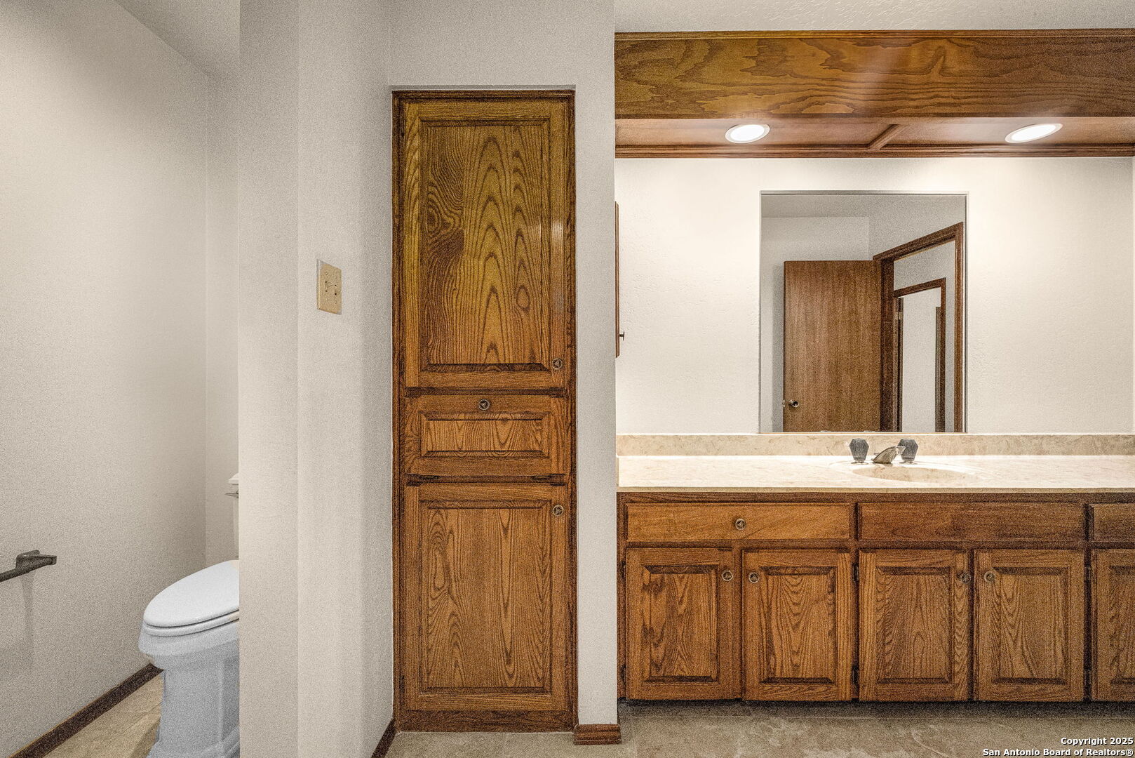9606 Meadow Rue Garden Ridge, TX 78266 - Photo 43 of 60 a bathroom with a sink a toilet and a mirror
