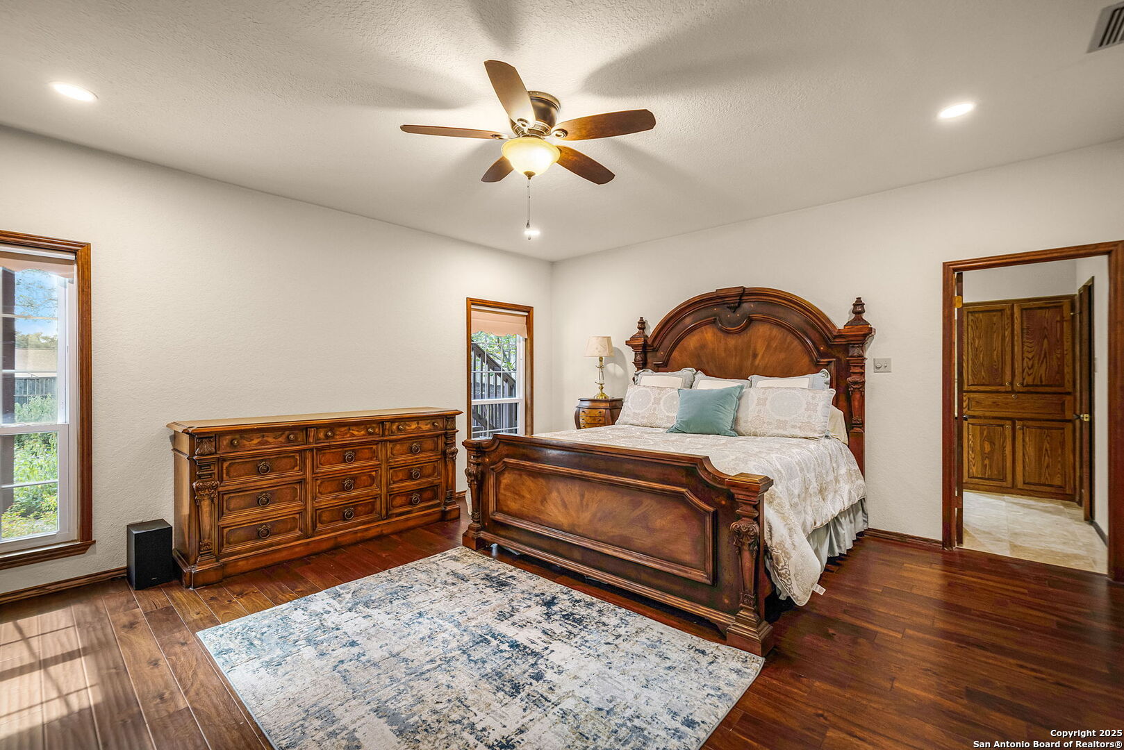 9606 Meadow Rue Garden Ridge, TX 78266 - Photo 46 of 60 a bedroom with a bed and wooden floor