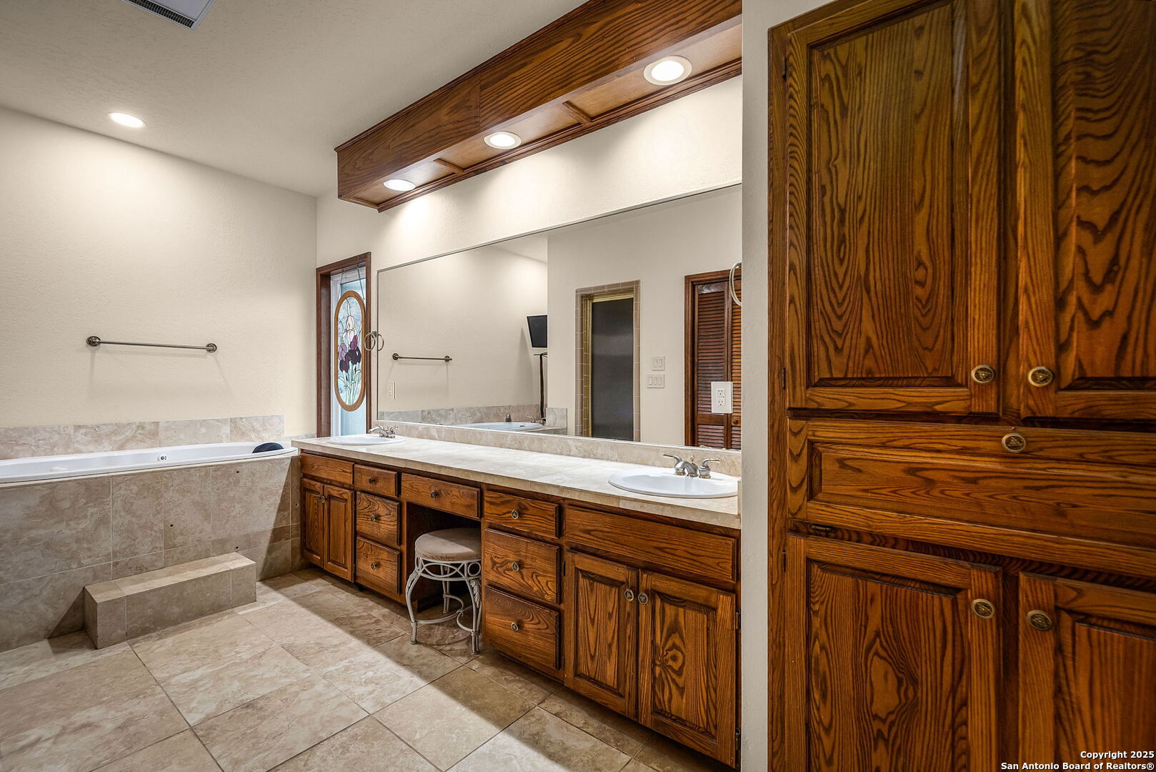 9606 Meadow Rue Garden Ridge, TX 78266 - Photo 49 of 60 a bathroom with double vanity and a bathtub