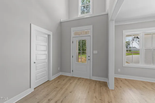 an empty room with windows and closet