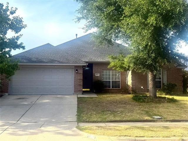 a front view of a house with a yard garage and outdoor seating