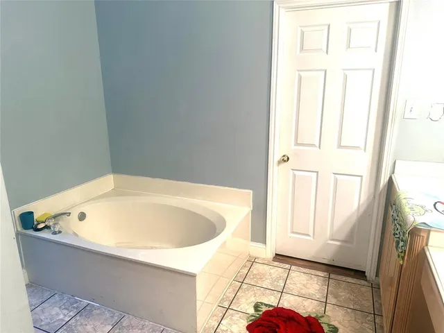 a bathroom with a bathtub and window