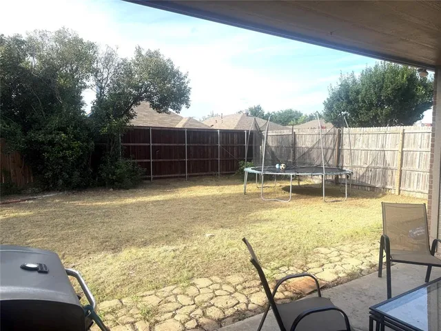 a view of a swimming pool with chair and tables