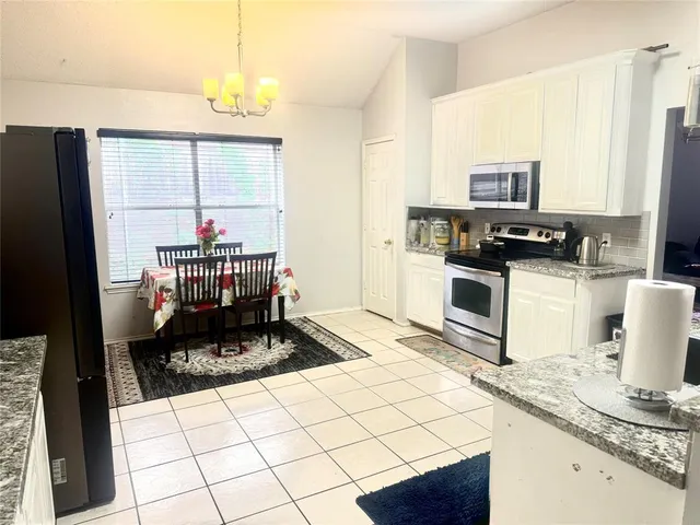 a kitchen with a stove a sink and a refrigerator