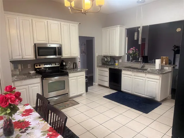 a kitchen with a stove a sink and a microwave