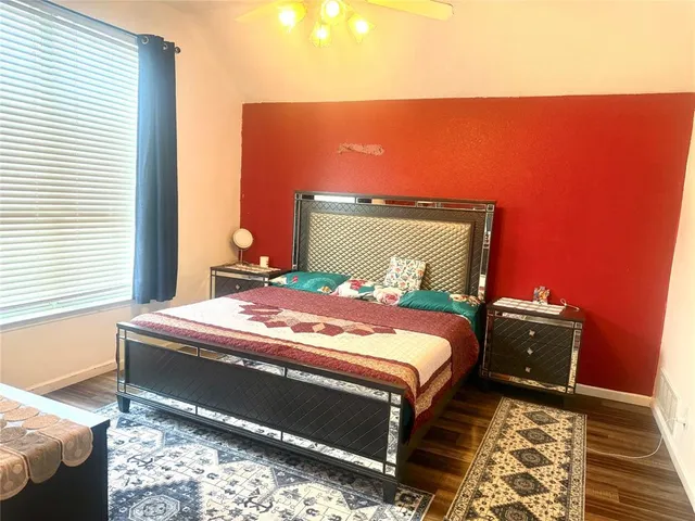 a bed sitting in a bedroom next to a window