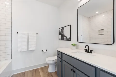 a bathroom with a toilet sink and mirror