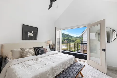 a bedroom with a large bed and a window