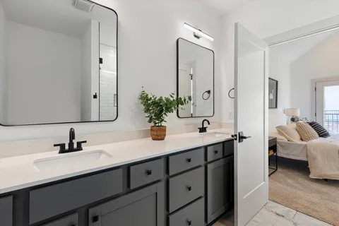 a bathroom with a sink double vanity and a mirror