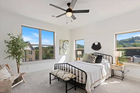 a bedroom with a bed and a large window