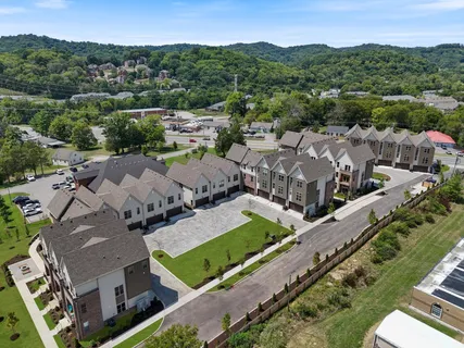an aerial view of multiple houses with yard
