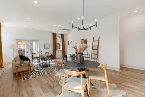 a view of a dining room with furniture wooden floor and chandelier