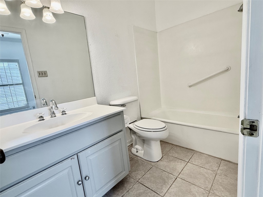 1307 Kinney Avenue, Unit 133 Austin, TX 78704 - Photo 14 of 24 a bathroom with a toilet sink and mirror