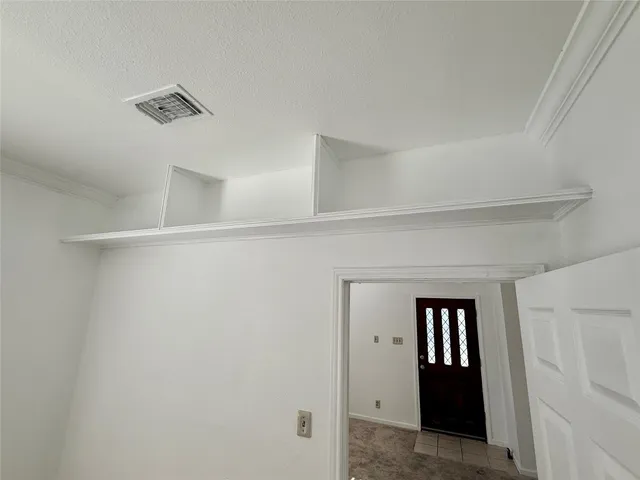 a view of a kitchen with a sink and a refrigerator