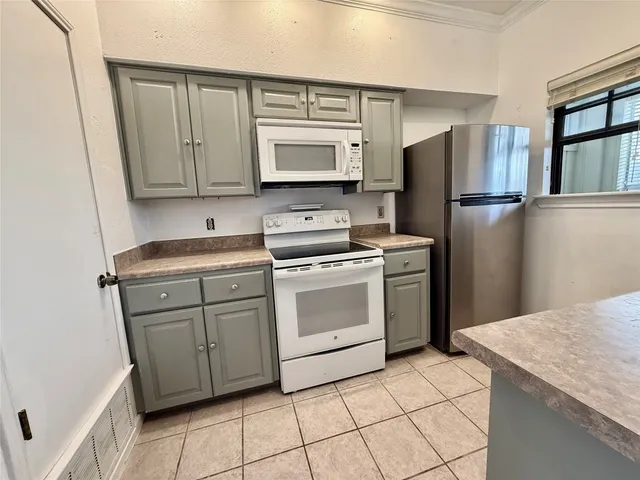 a kitchen with appliances cabinets and a counter top space