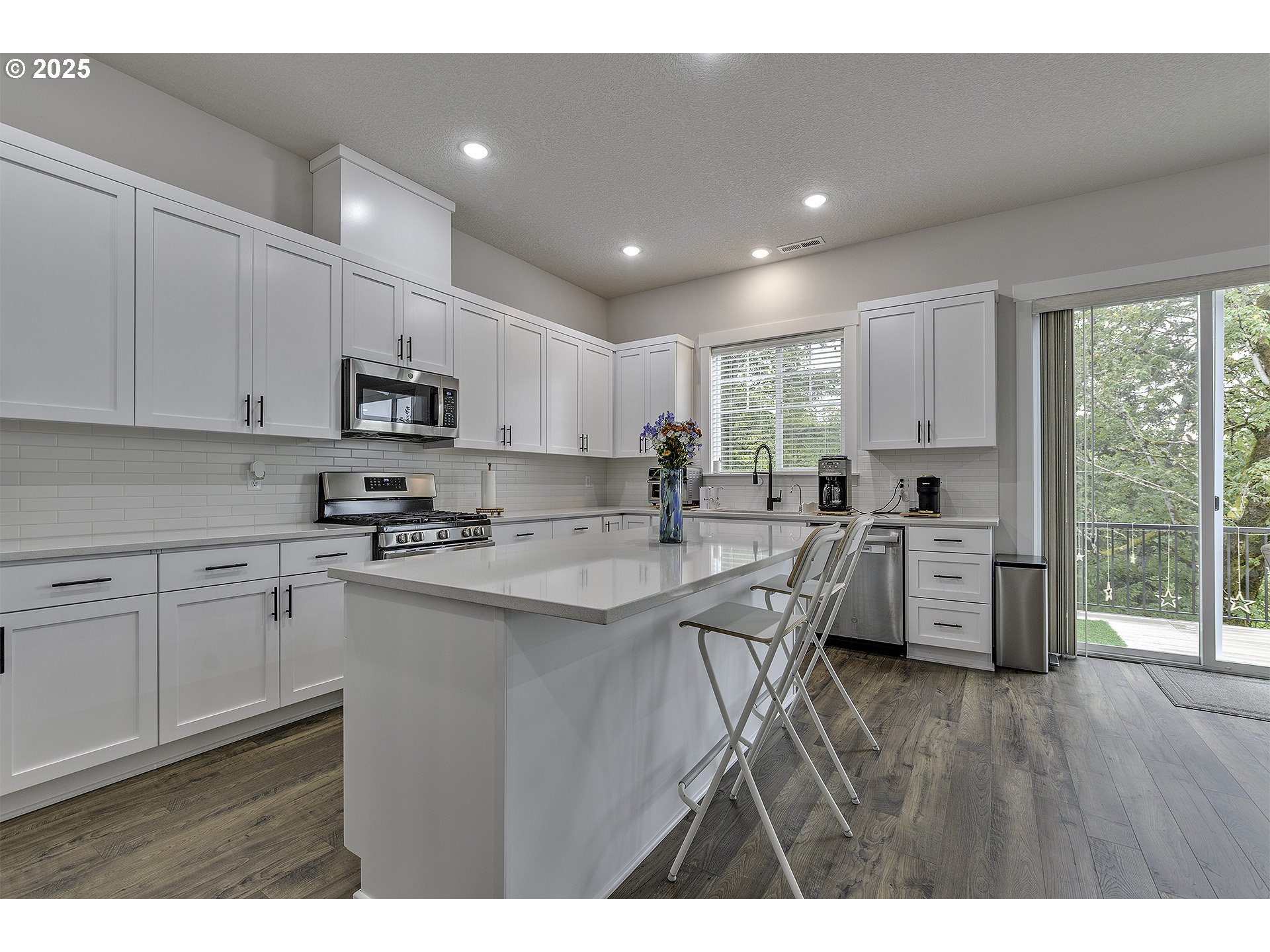 15080 Northwest Legend Street Portland, OR 97229 - Photo 11 of 38 a kitchen with white cabinets stove and sink