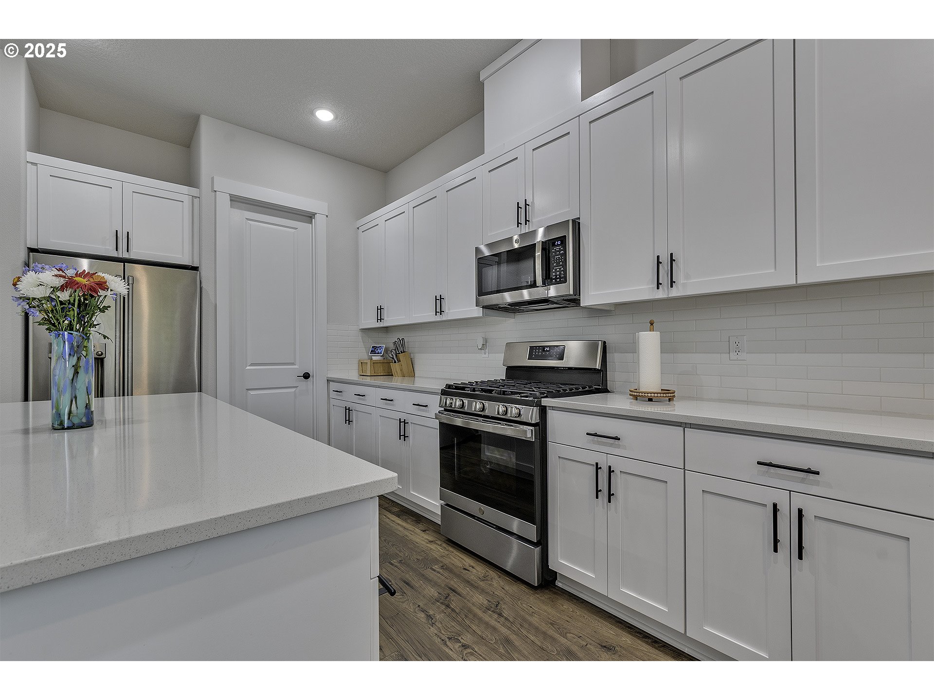 15080 Northwest Legend Street Portland, OR 97229 - Photo 14 of 38 a kitchen with stainless steel appliances granite countertop a sink a stove a refrigerator and white cabinets