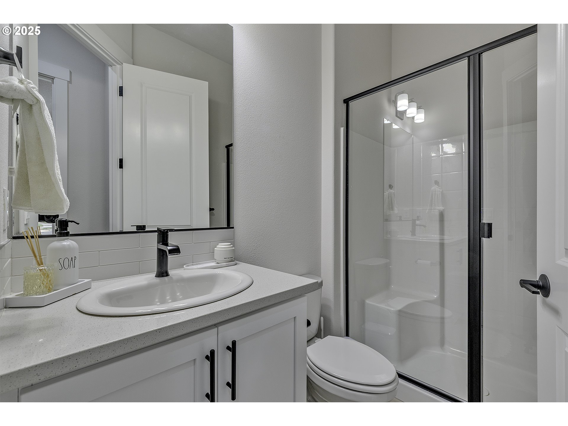 15080 Northwest Legend Street Portland, OR 97229 - Photo 19 of 38 a bathroom with a sink a toilet a mirror and shower