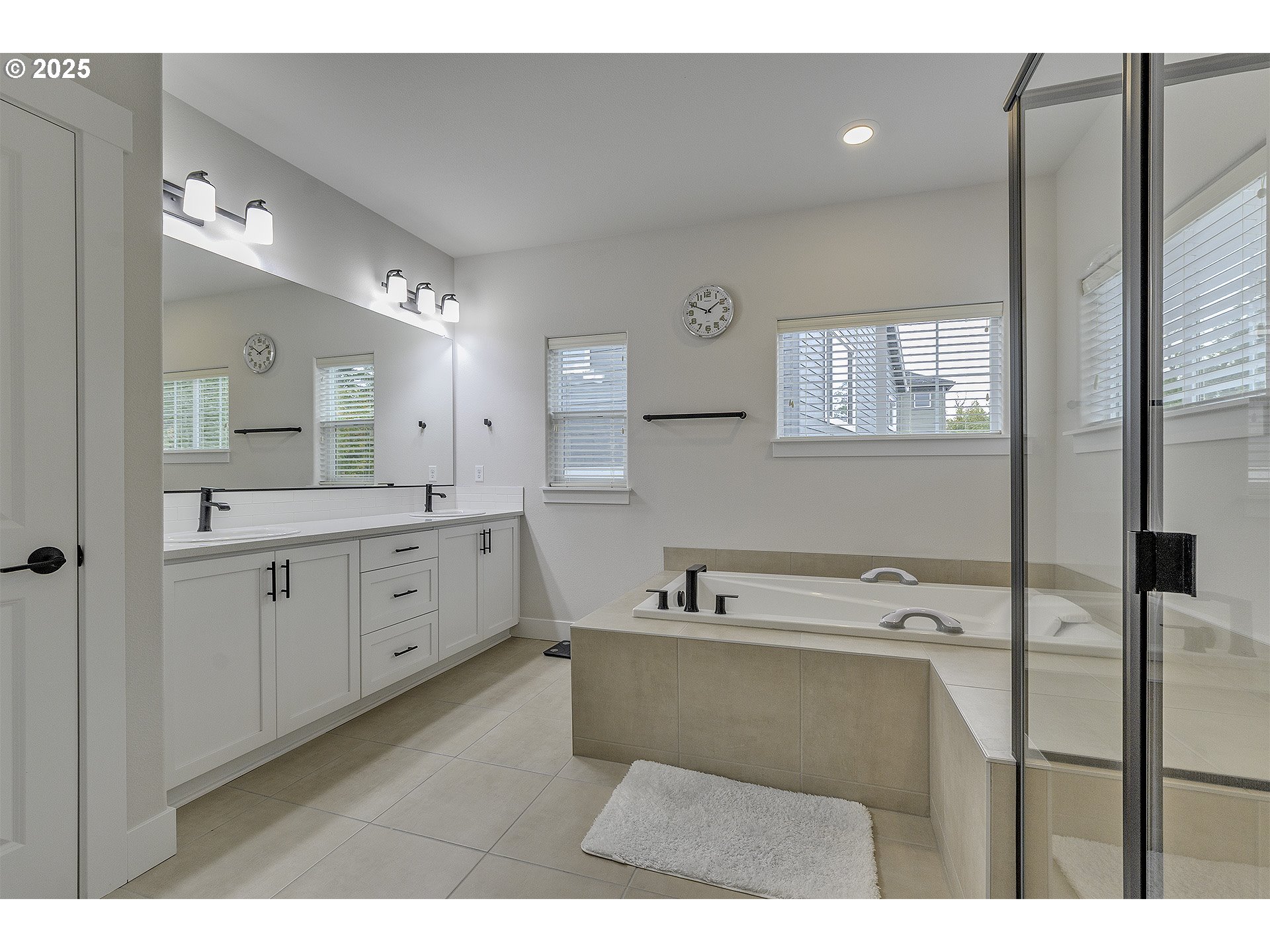 15080 Northwest Legend Street Portland, OR 97229 - Photo 23 of 38 a bathroom with a sink mirror and a bathtub