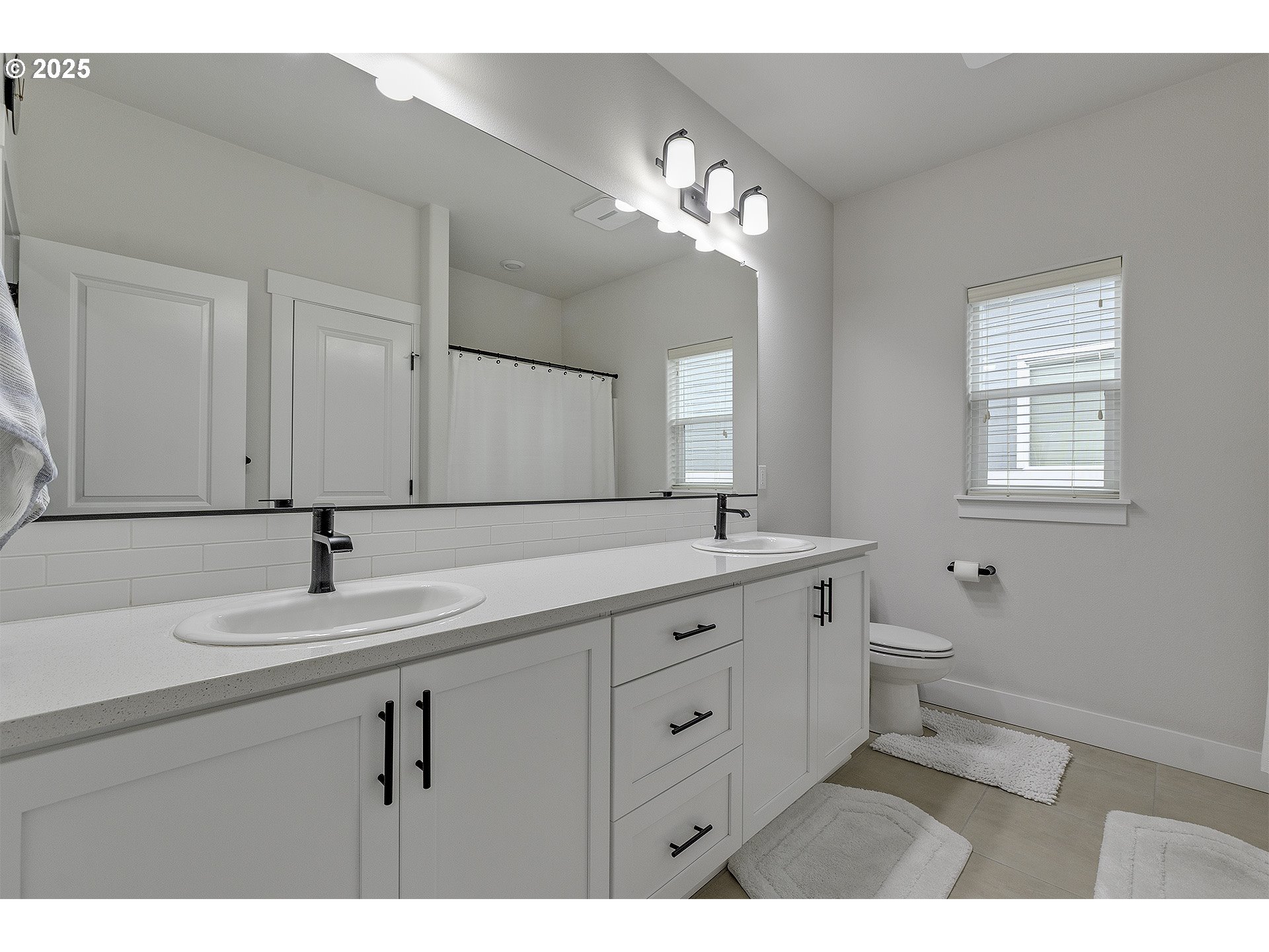 15080 Northwest Legend Street Portland, OR 97229 - Photo 29 of 38 a bathroom with a sink and a mirror