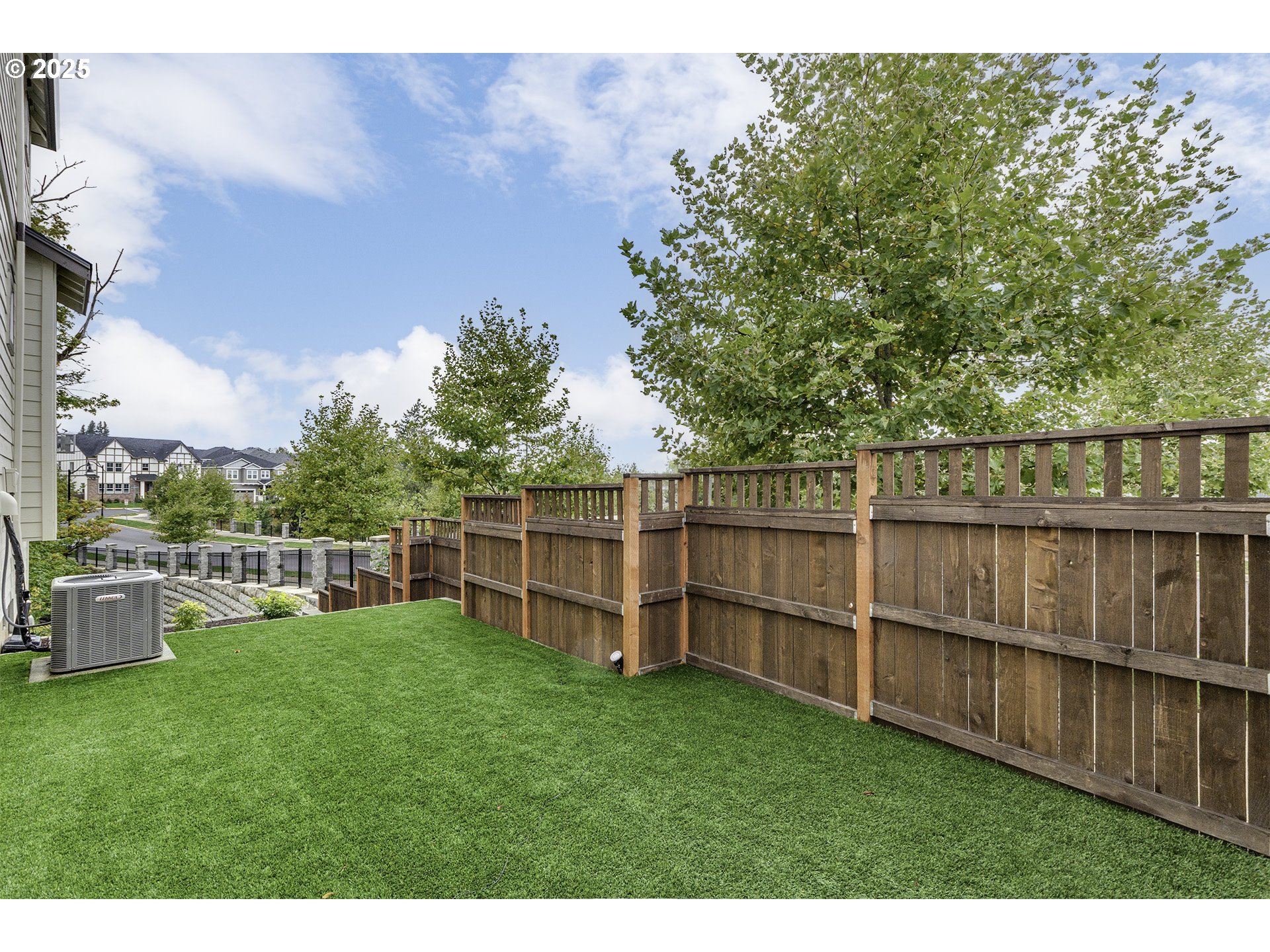 15080 Northwest Legend Street Portland, OR 97229 - Photo 32 of 38 a view of a backyard with a wooden fence