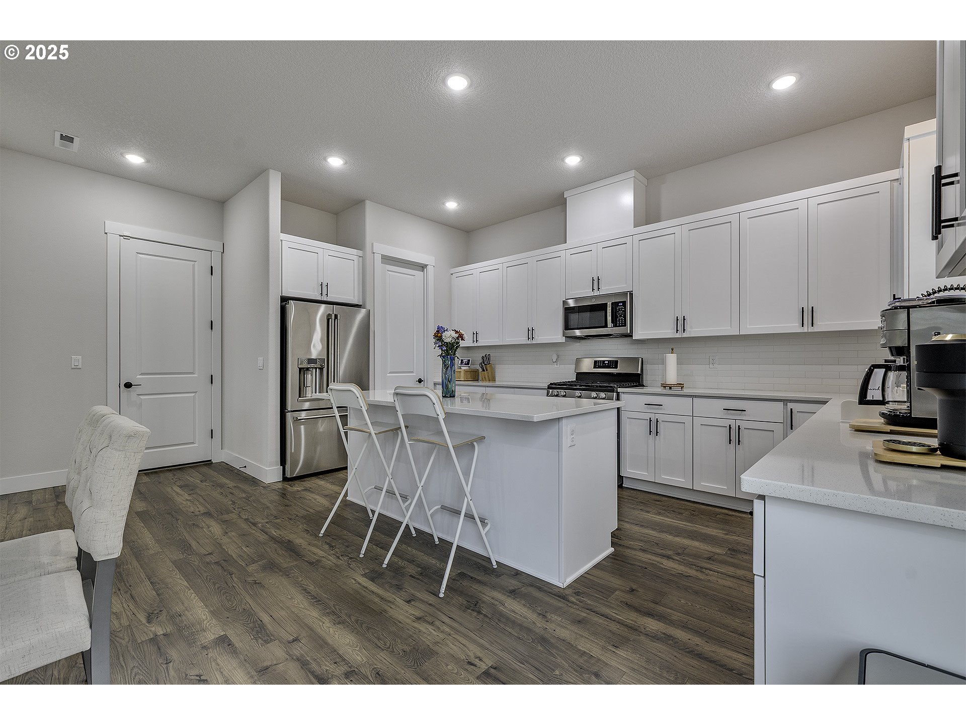 15080 Northwest Legend Street Portland, OR 97229 - Photo 10 of 38 a kitchen with white cabinets and stainless steel appliances