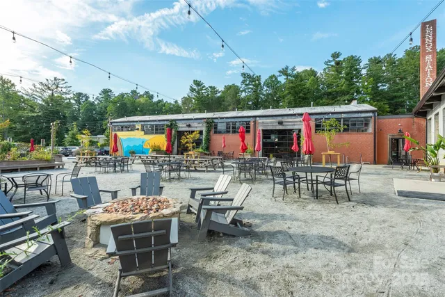 a outdoor space with lots of tables a garden and chairs