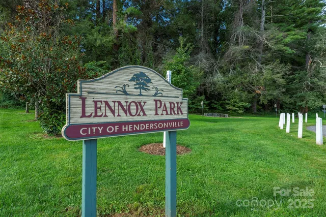 a sign that is sitting on a lush green field