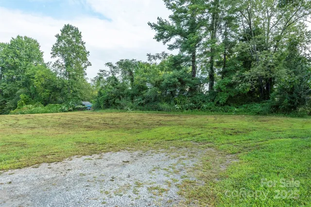 a view of outdoor space with field and trees all around