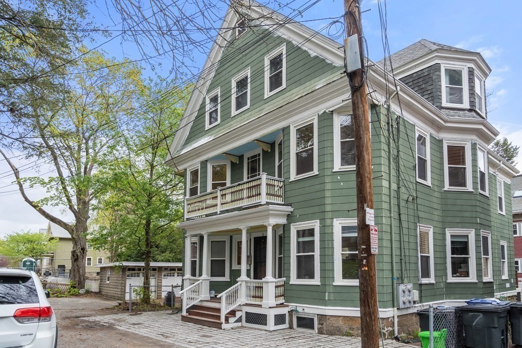 3 Adelaide Terrace, Unit 2 Boston, MA 02130 - Photo 15 of 16 a view of a brick house with a chairs and table in a patio