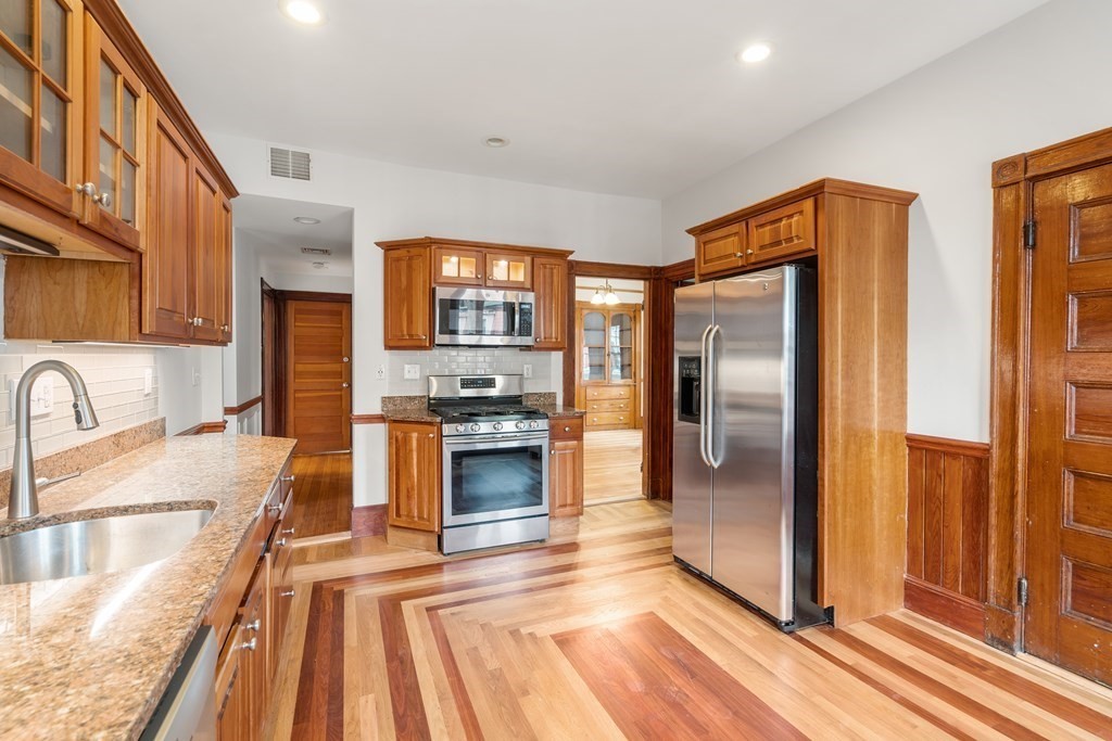 3 Adelaide Terrace, Unit 2 Boston, MA 02130 - Photo 3 of 16 a kitchen with stainless steel appliances granite countertop a refrigerator and a sink