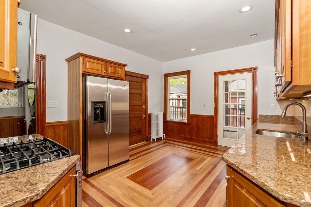 3 Adelaide Terrace, Unit 2 Boston, MA 02130 - Photo 4 of 16 a kitchen with stainless steel appliances granite countertop a sink and a refrigerator