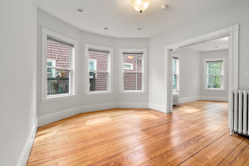 3 Adelaide Terrace, Unit 2 Boston, MA 02130 - Photo 6 of 16 a view of an empty room with wooden floor and a window