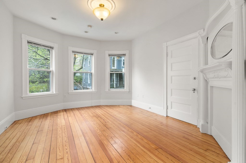 3 Adelaide Terrace, Unit 2 Boston, MA 02130 - Photo 7 of 16 an empty room with wooden floor and windows