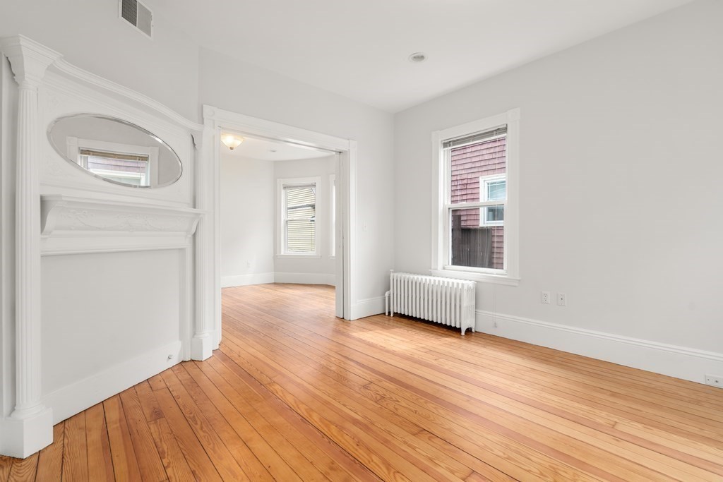3 Adelaide Terrace, Unit 2 Boston, MA 02130 - Photo 8 of 16 a view of an empty room with wooden floor and a window