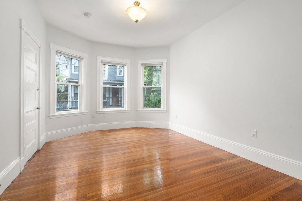 3 Adelaide Terrace, Unit 2 Boston, MA 02130 - Photo 9 of 16 a view of an empty room with wooden floor and a window
