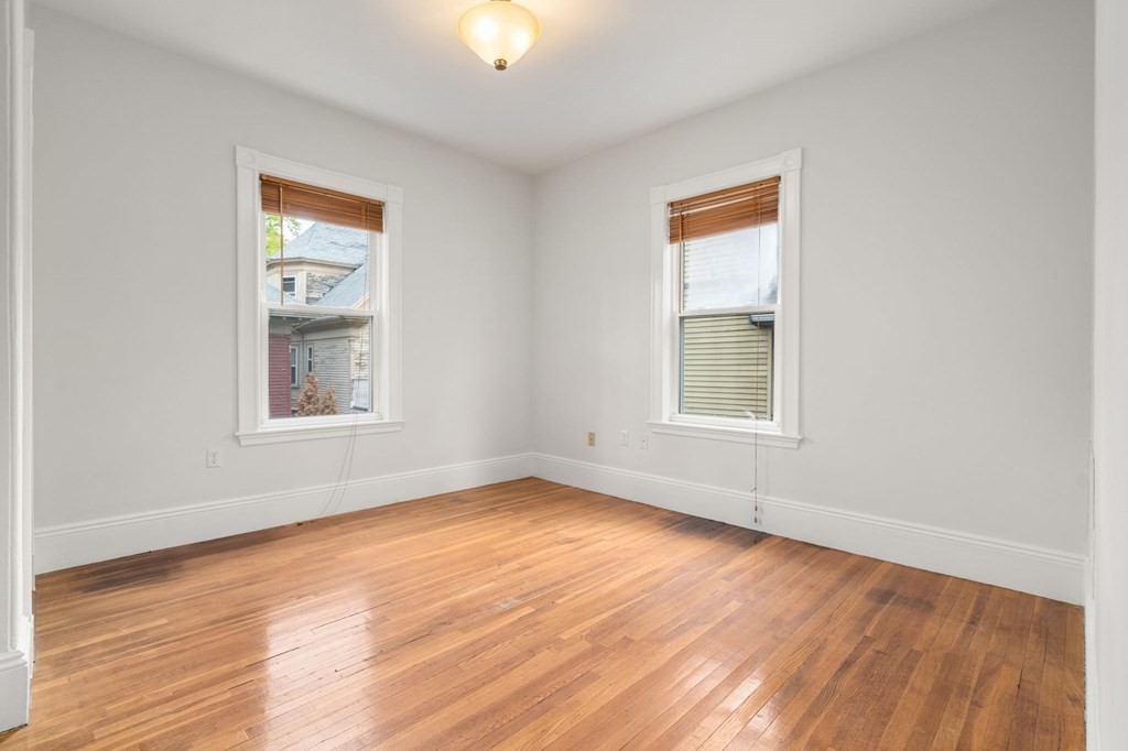 3 Adelaide Terrace, Unit 2 Boston, MA 02130 - Photo 10 of 16 a view of an empty room with wooden floor and a window