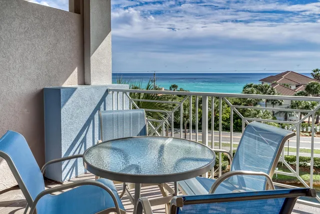 a balcony with table and chairs