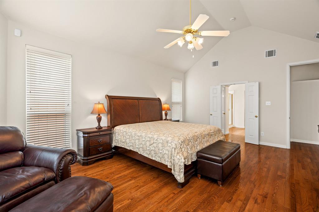 2012 Burnside Drive Allen, TX 75013 - Photo 15 of 40 a bedroom with a bed couch and a chandelier