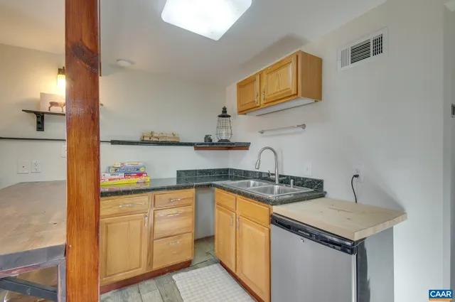 a kitchen with granite countertop a sink and cabinets