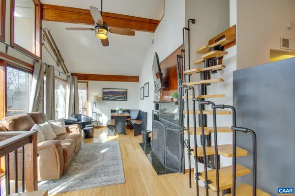 a living room with furniture and floor to ceiling windows