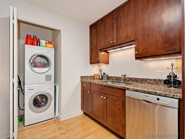 60 East Monroe Street, Unit 1906 Chicago, IL 60603 - Photo 13 of 20 a utility room with sink dryer and washer