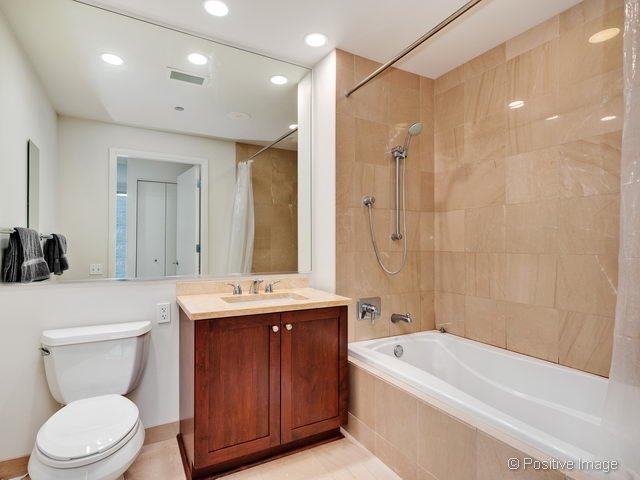 60 East Monroe Street, Unit 1906 Chicago, IL 60603 - Photo 16 of 20 a bathroom with a sink a toilet and shower