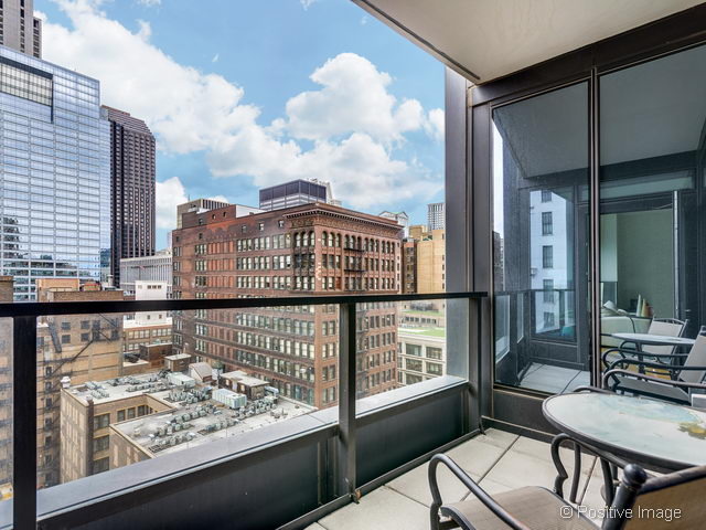 60 East Monroe Street, Unit 1906 Chicago, IL 60603 - Photo 19 of 20 a view of a balcony with wooden chairs
