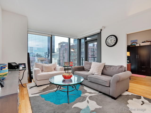 60 East Monroe Street, Unit 1906 Chicago, IL 60603 - Photo 6 of 20 a living room with furniture a table and a large window
